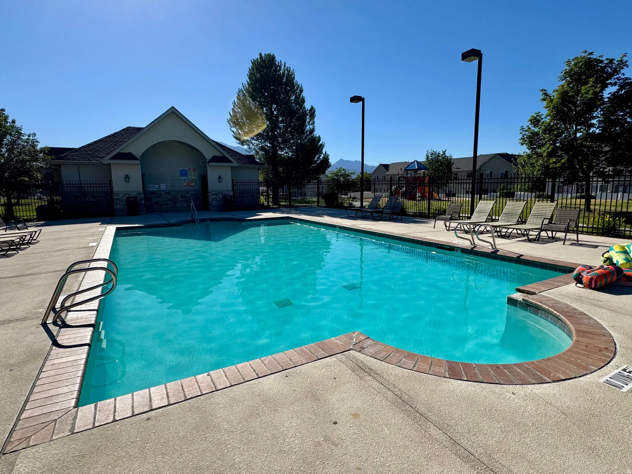 Community swimming pool area featuring a perimeter fence
