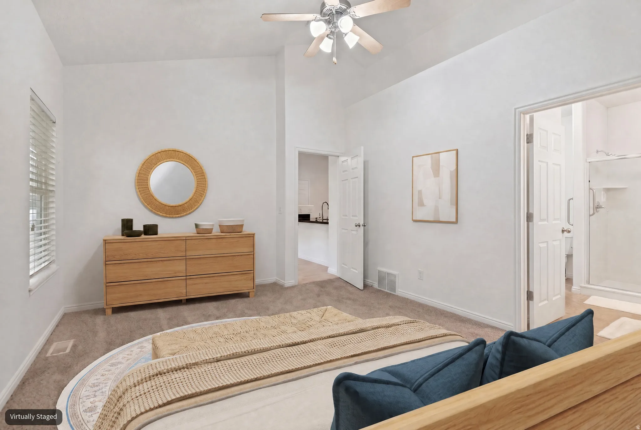 Primary bedroom with vaulted ceiling and new carpet (virtually staged)