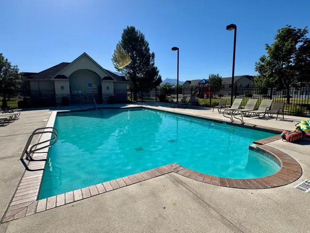 Community swimming pool area featuring a perimeter fence