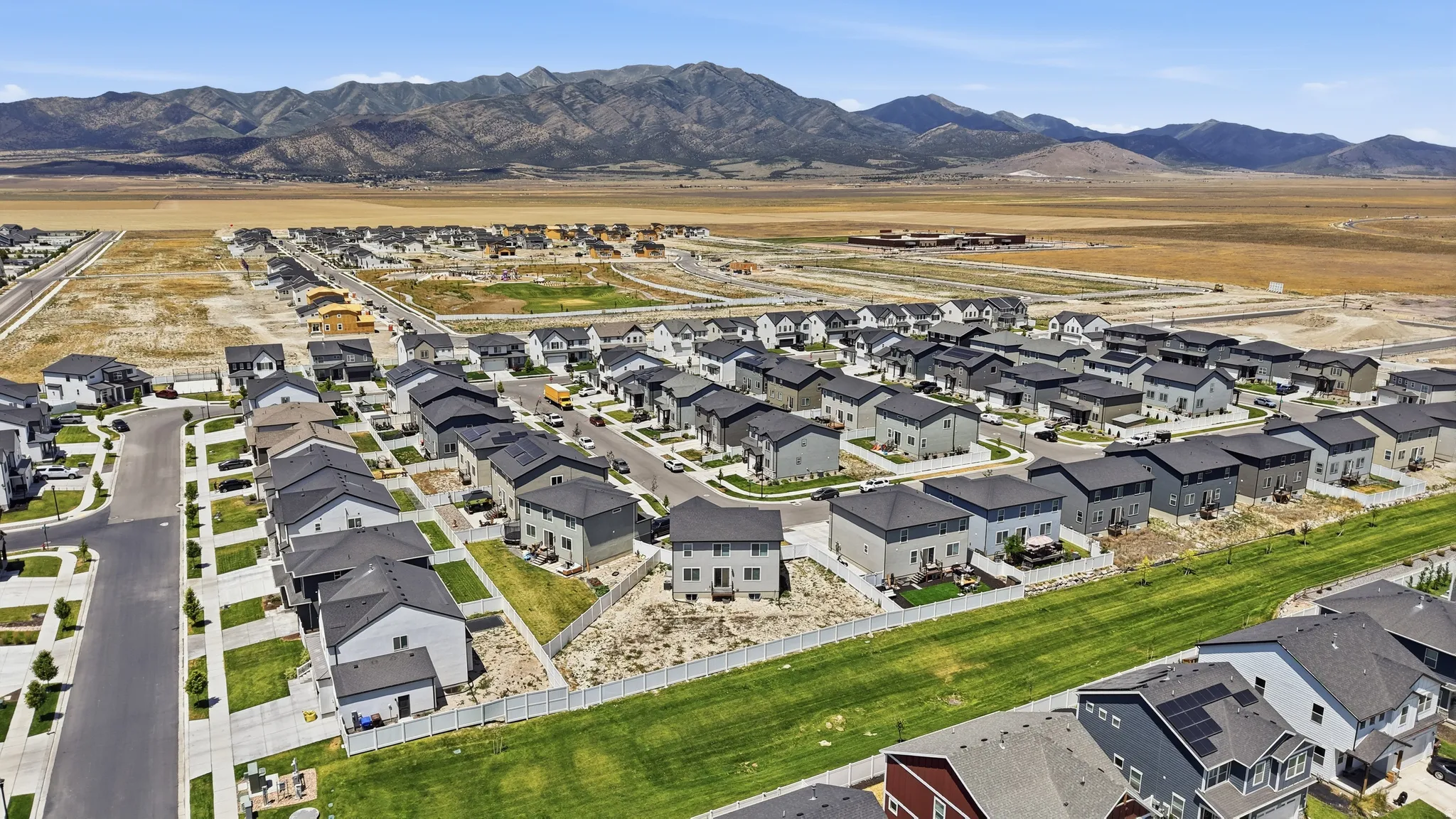 Expansive residential development featuring contemporary homes with dark shingle roofs