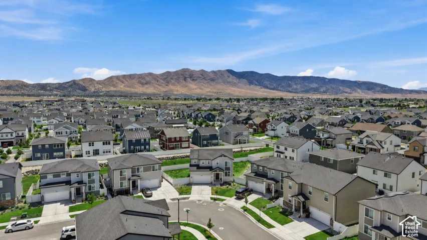 Residential community featuring a variety of single-family homes with mountain backdrops. Digitally enhanced to illustrate landscaping option.