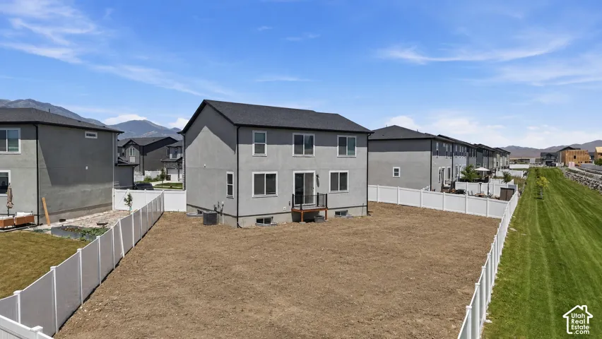 Contemporary gray stucco exterior with a dark shingle roof