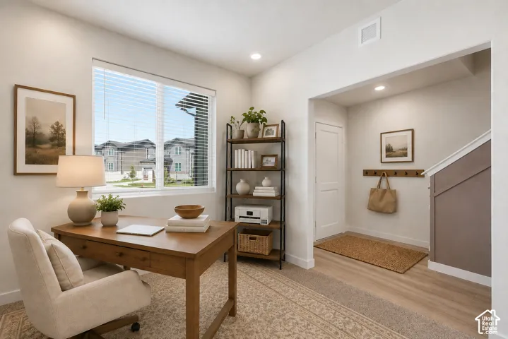 Dedicated space with a large window, recessed lighting, and a shelving unit