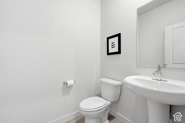 Pedestal sink with chrome faucet and polished mirror