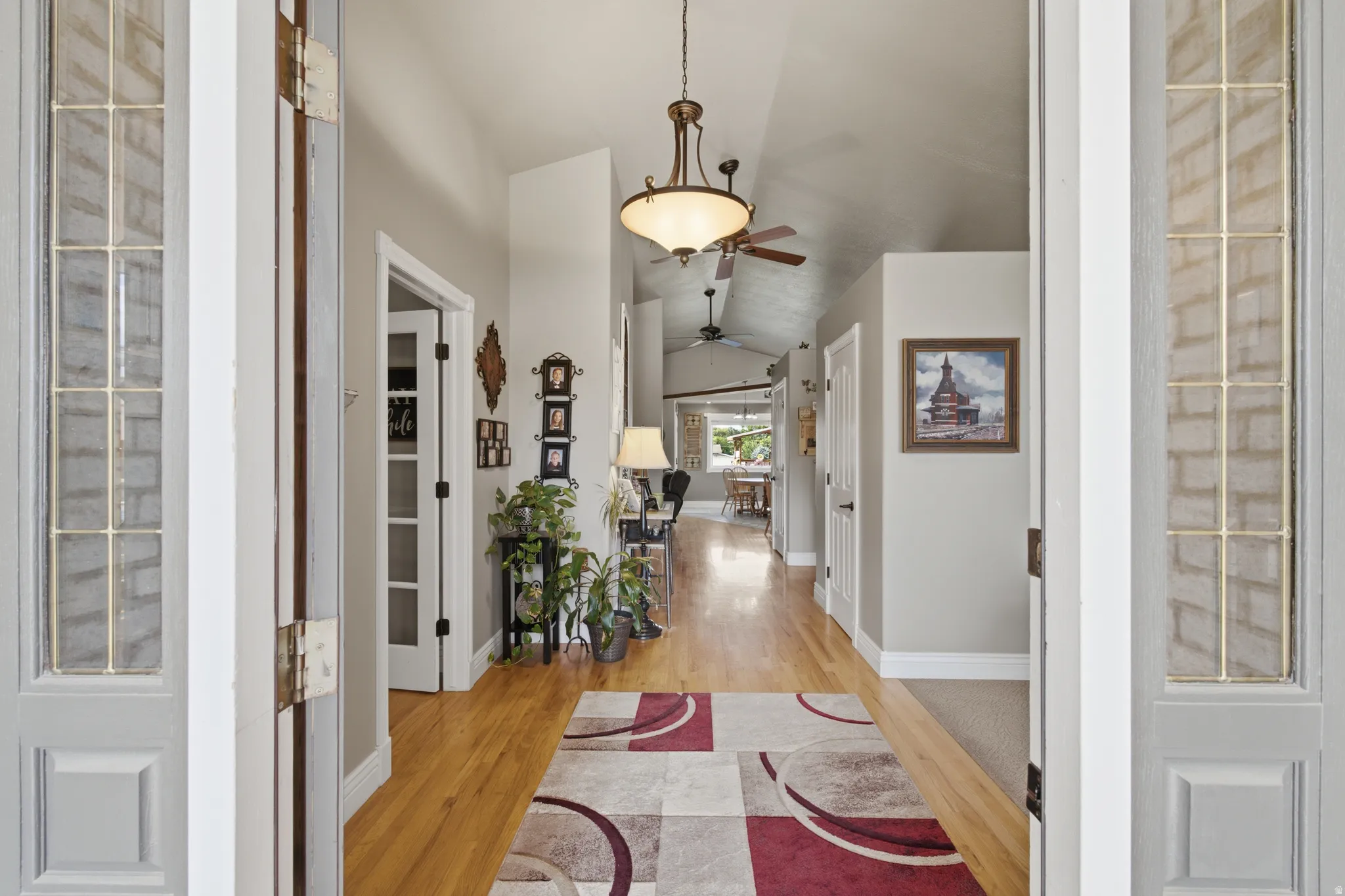 Entryway featuring wood-finish flooring, vaulted ceilings, and recessed lighting