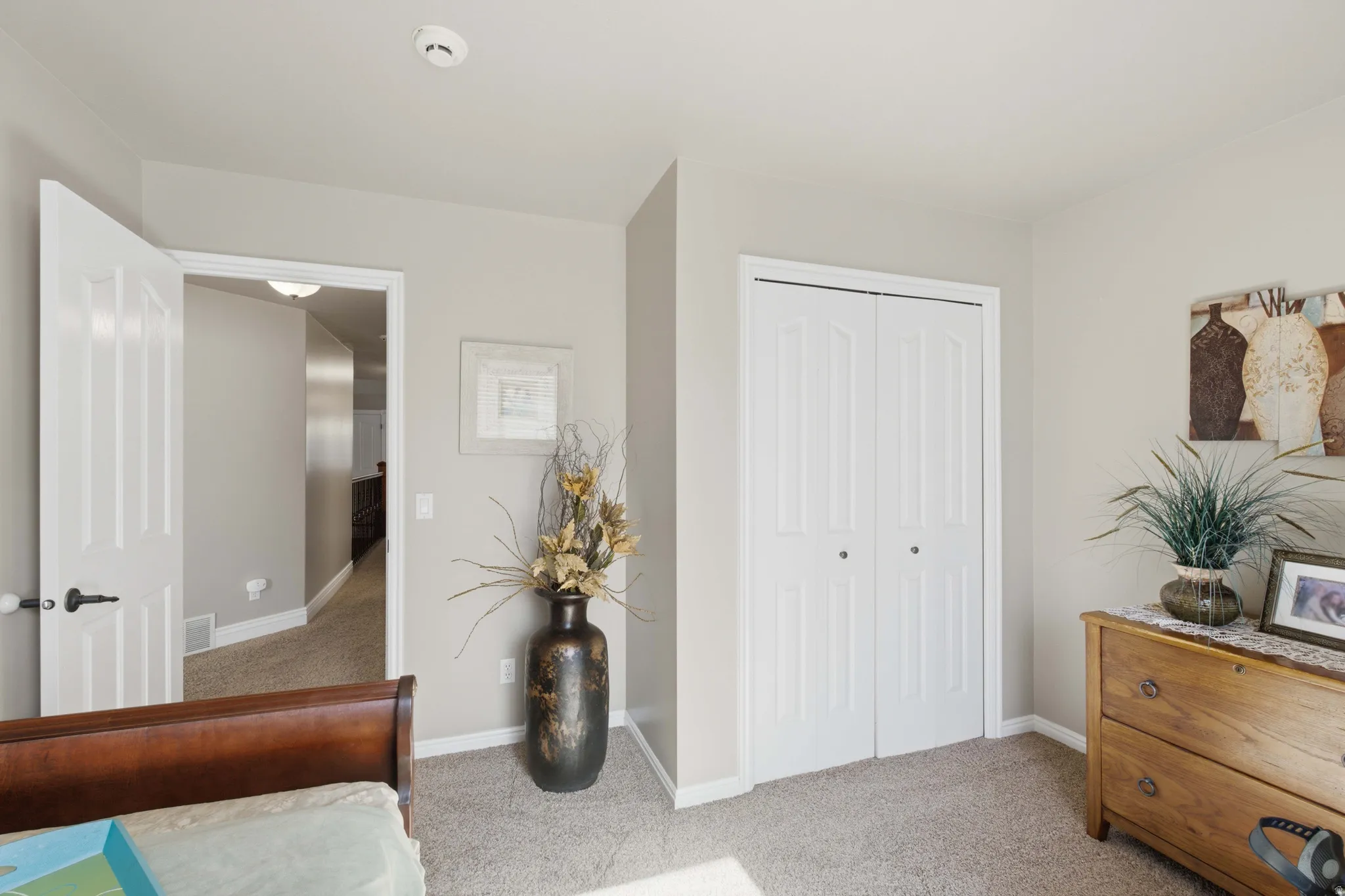 Carpeted interior space featuring light neutral wall paint