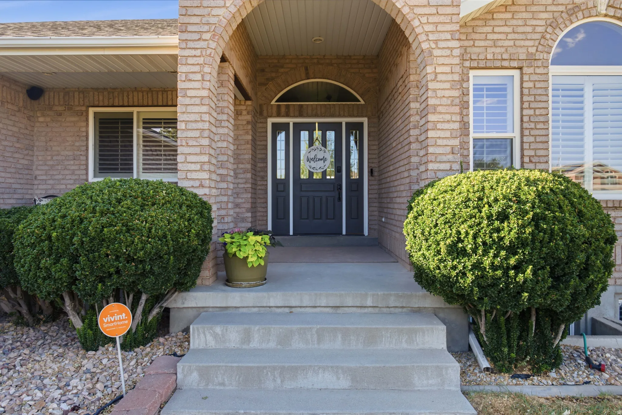 Brick facade residence with an arched entryway