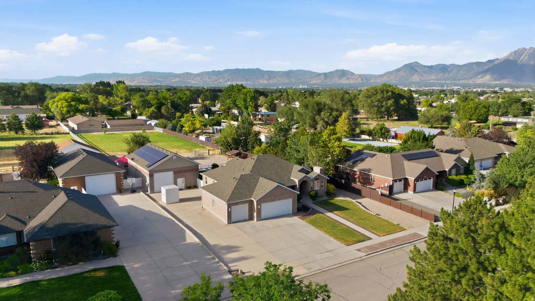 Aerial perspective showcasing multiple properties with durable roofing and attached garages
