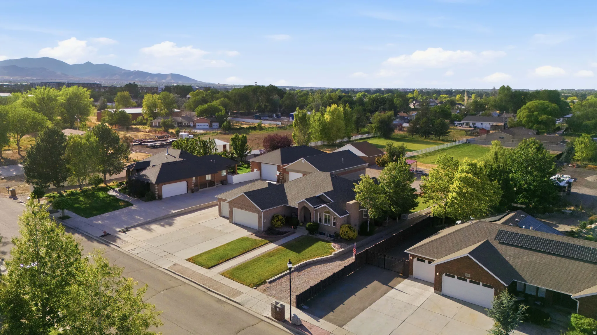 Expansive residential property featuring a brick exterior and multiple garage bays