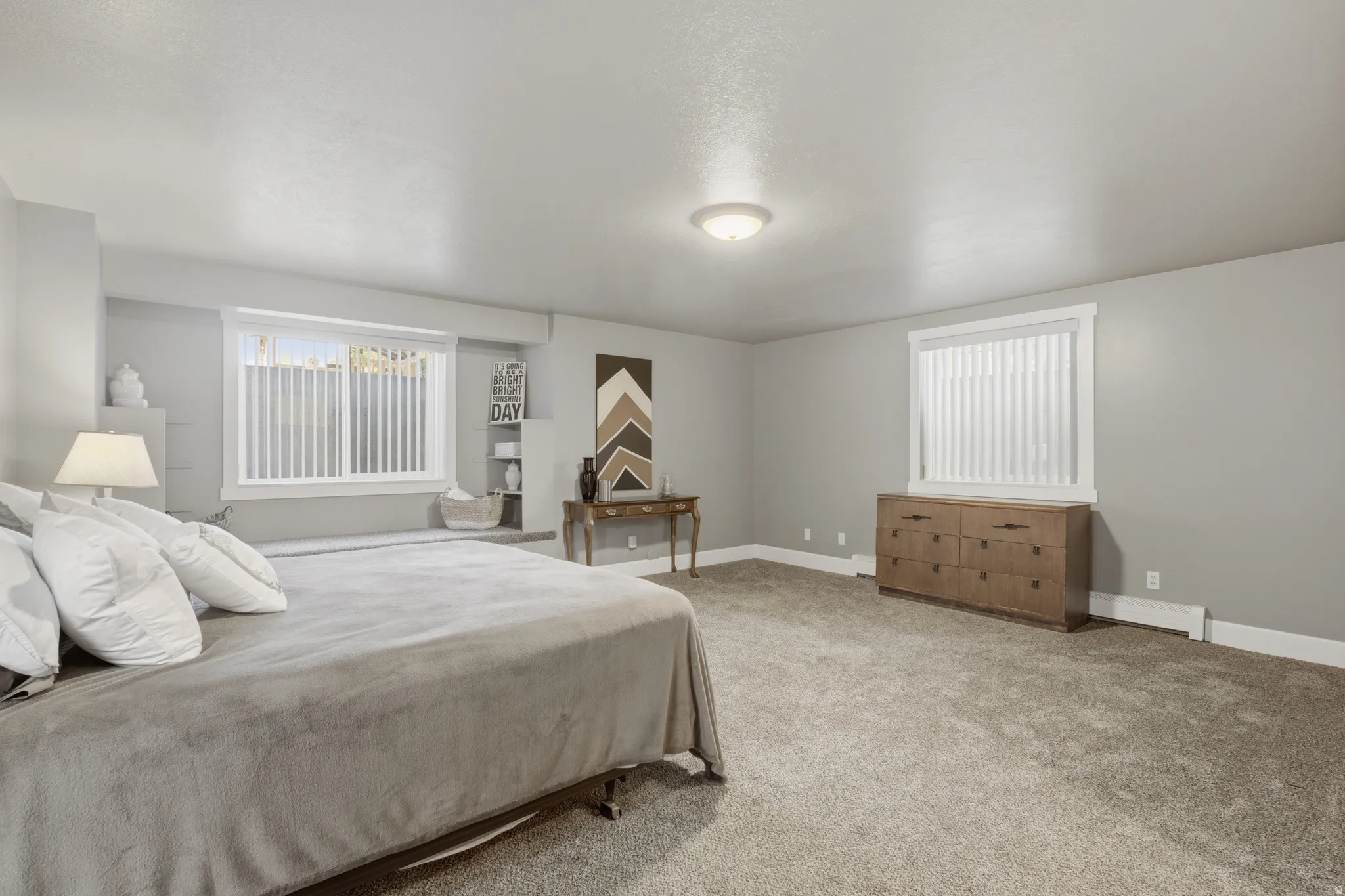 Spacious room featuring neutral carpeting and light gray walls
