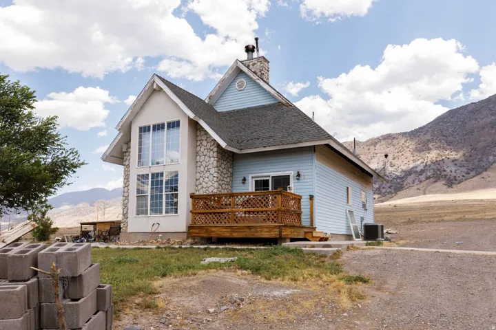 Gable roof structure with light blue siding and stone facade