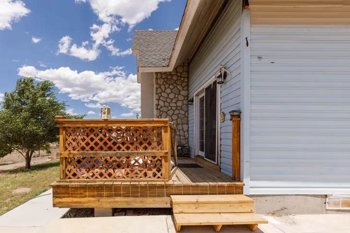 Wood-finish deck with lattice paneling and two-step entry