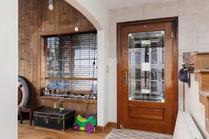 Solid wood entry door with decorative glass panels and brass hardware