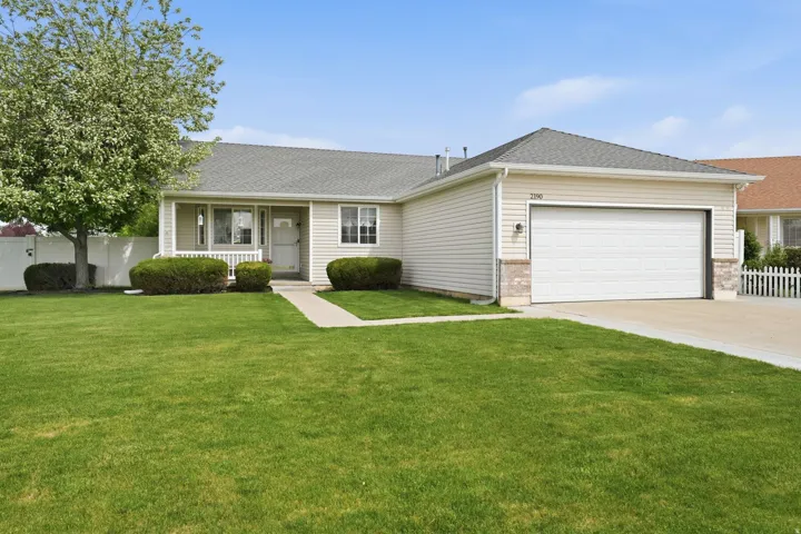 Ranch-style exterior with beige siding and a gray shingle roof