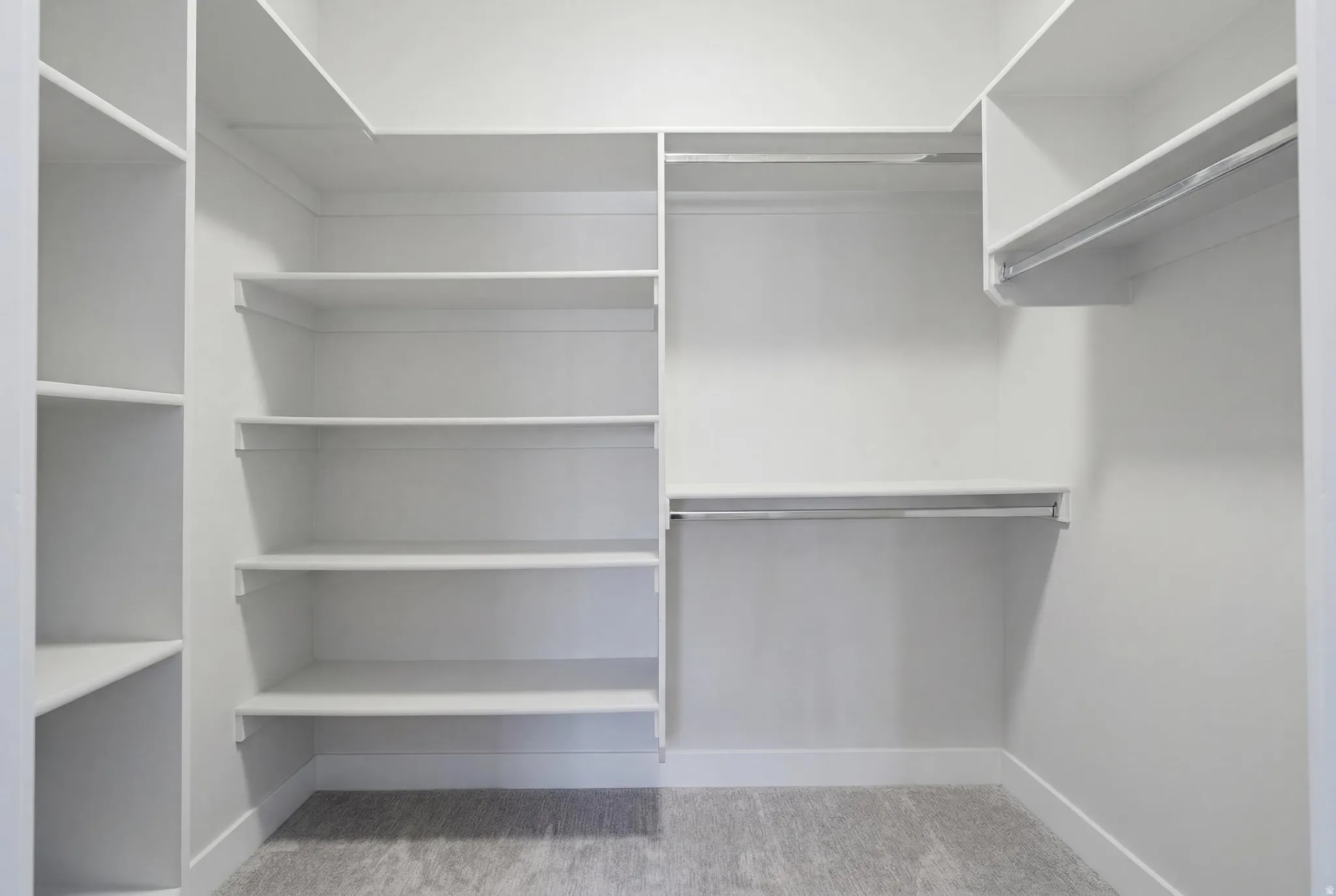 Custom closet system featuring multiple shelving units and integrated hanging rods