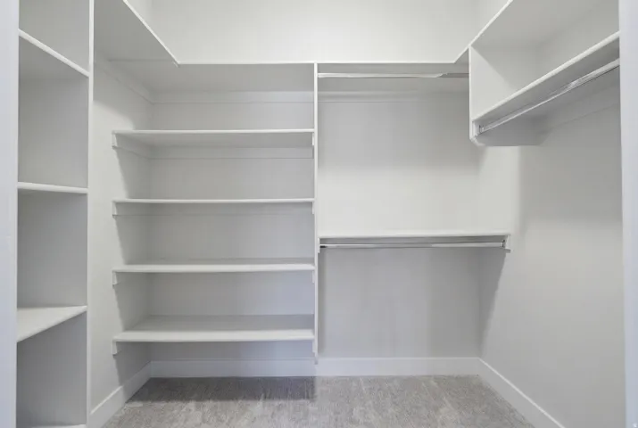 Custom closet system featuring multiple shelving units and integrated hanging rods