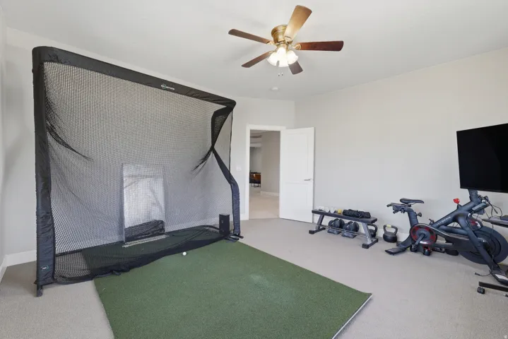 Versatile room featuring carpeting, a neutral wall color, and a ceiling fan with integrated lighting