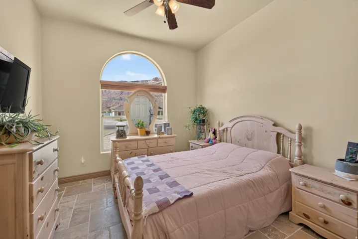 Arched window providing natural light and mountain scenery