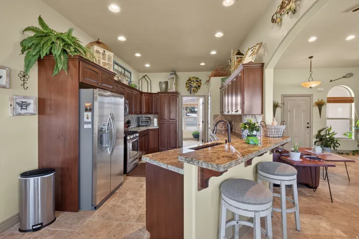 Kitchen featuring recessed lighting, stone tile flooring, and wood cabinetry