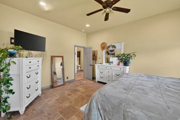 Spacious room featuring tile flooring, recessed lighting, and a ceiling fan
