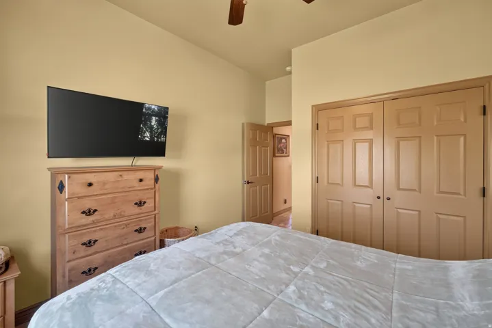 Bedroom featuring a vaulted ceiling and a ceiling fan