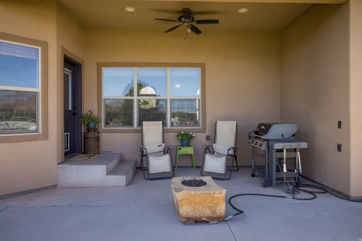 Covered patio featuring a ceiling fan, recessed lighting, and a built-in fire pit