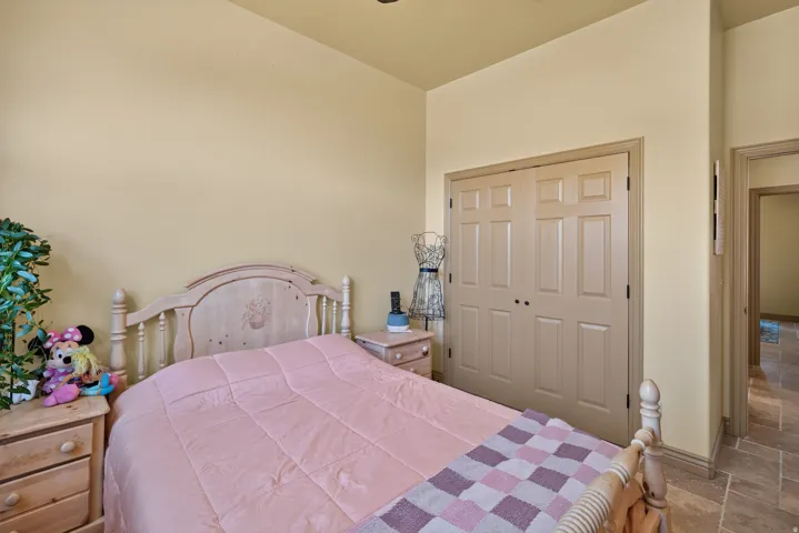Bedroom featuring light-toned walls, recessed lighting, and tile flooring