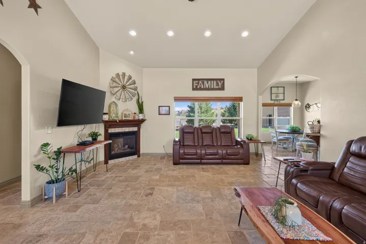 Vaulted ceilings with recessed lighting complement the tile flooring throughout this living space
