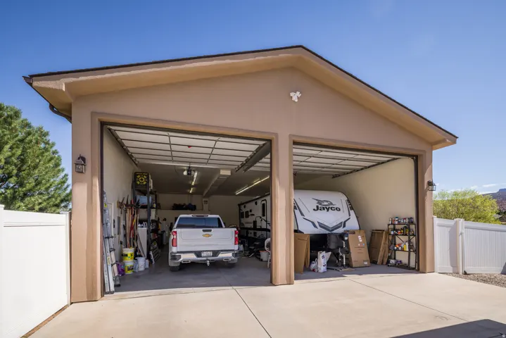 Two-bay garage with stucco exterior and concrete driveway