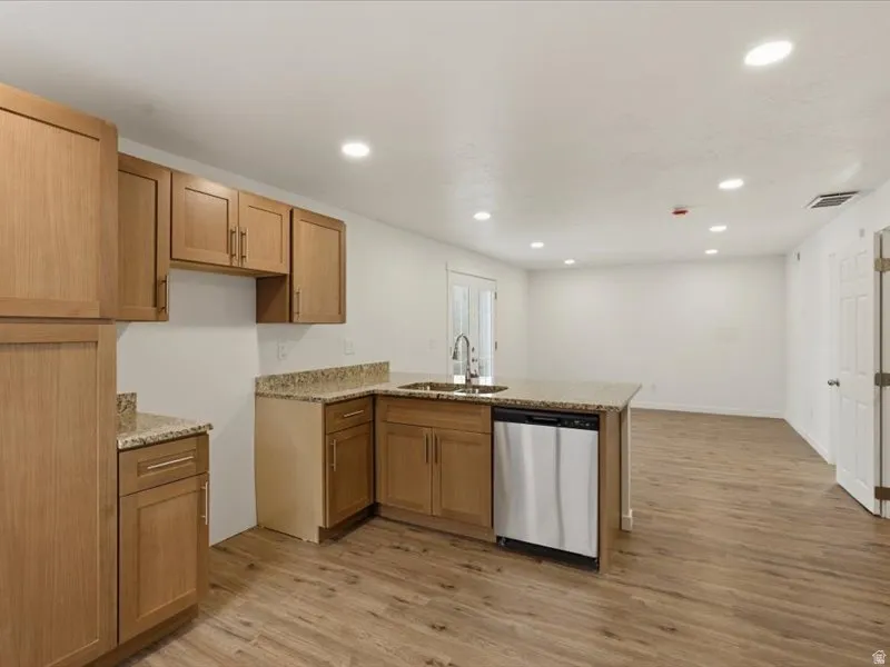 Kitchen featuring wood-finish flooring, recessed lighting, and light wood cabinetry
