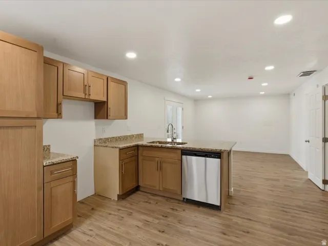 Kitchen featuring wood-finish flooring, recessed lighting, and light wood cabinetry