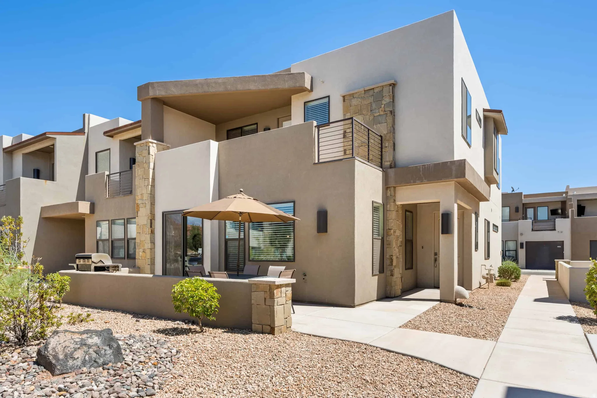 Contemporary exterior featuring stucco finishes and stone accents