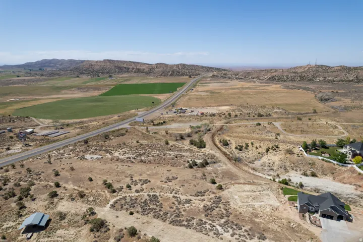 Expansive undeveloped land featuring varied topography and distant green fields