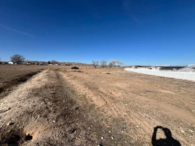 Expansive developable lot with a clear blue sky background