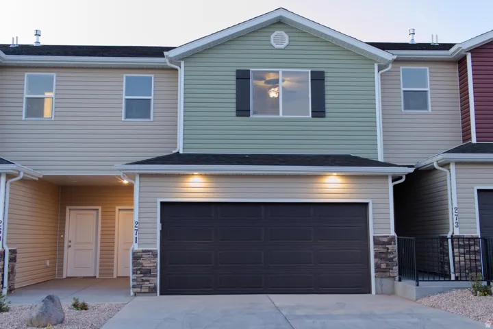 Multi-story facade featuring varied siding materials and a prominent garage