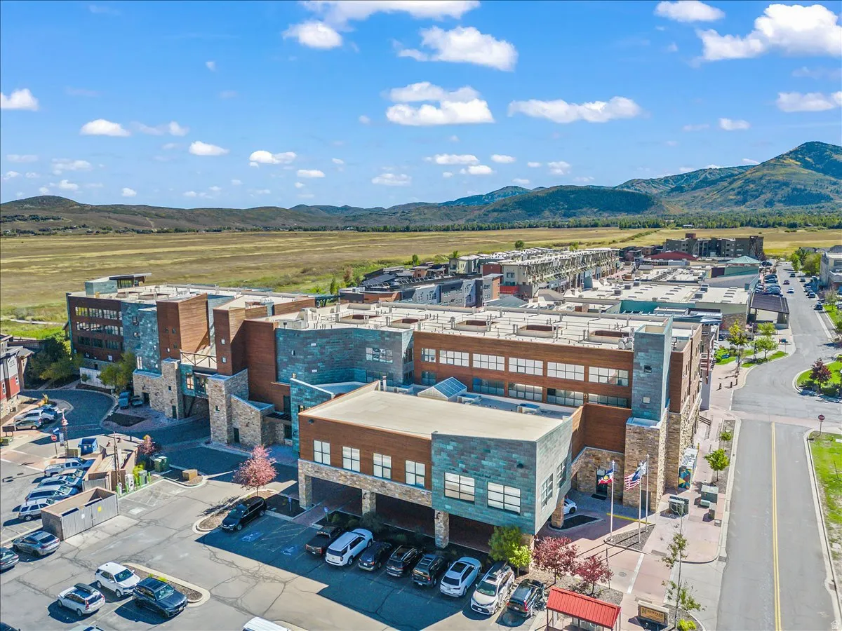 Mixed-use development featuring stone and wood-look facades with copper accents