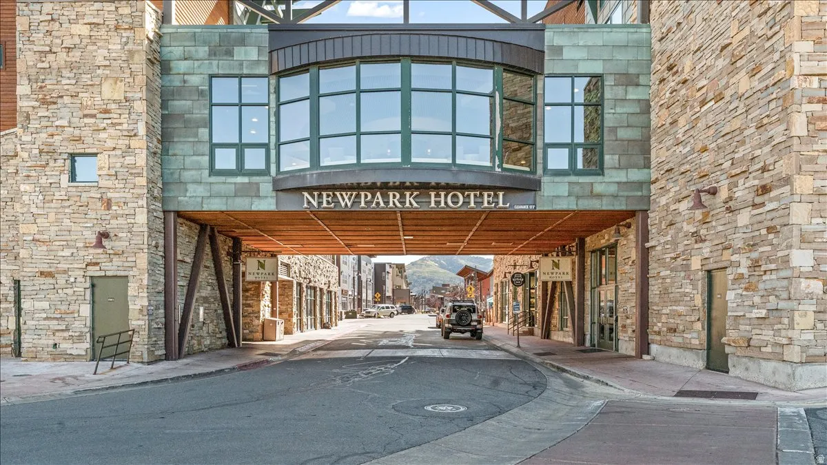 Stone-clad building facade featuring a prominent arched entryway