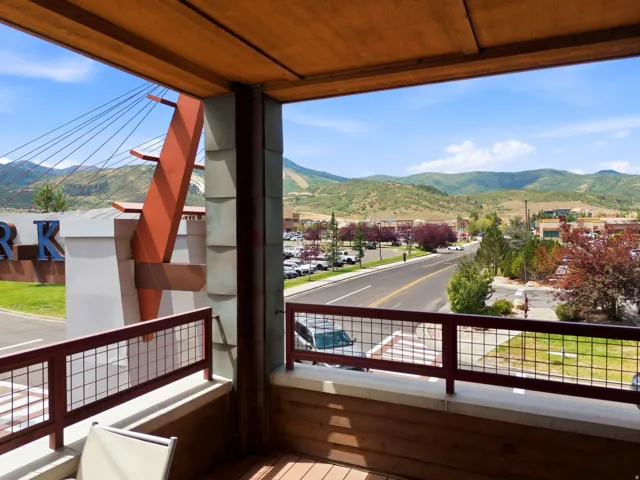 Balcony with a wood-finish ceiling, wood-finish flooring, and metal railing