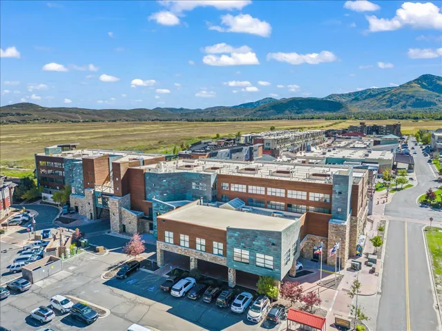 Mixed-use development featuring stone and wood-look facades with copper accents