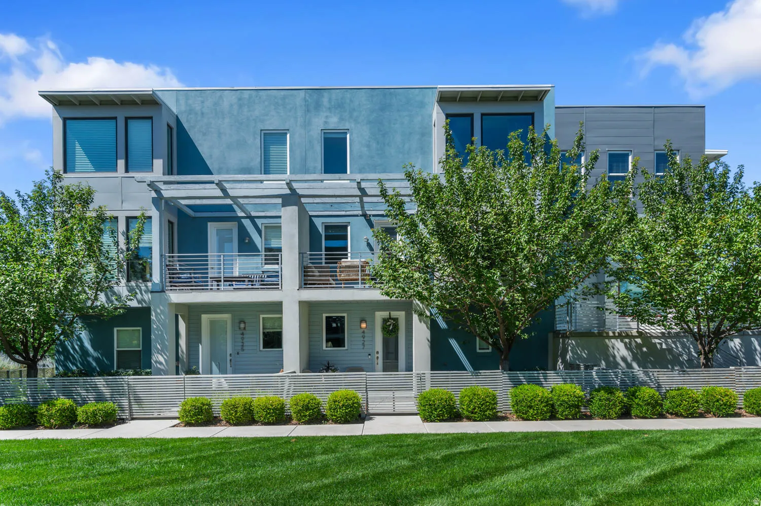 Contemporary multi-level townhome featuring a stucco and siding exterior