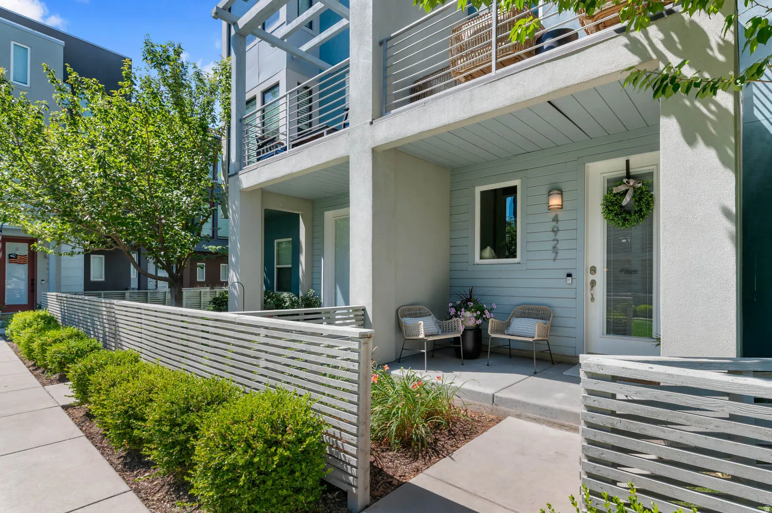 Modern architectural townhome featuring a private ground-level patio