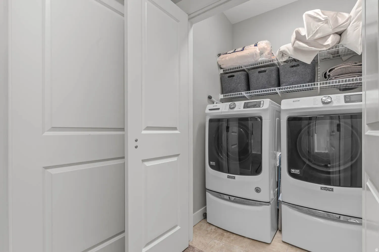 Dedicated laundry area featuring front-loading washer and dryer units