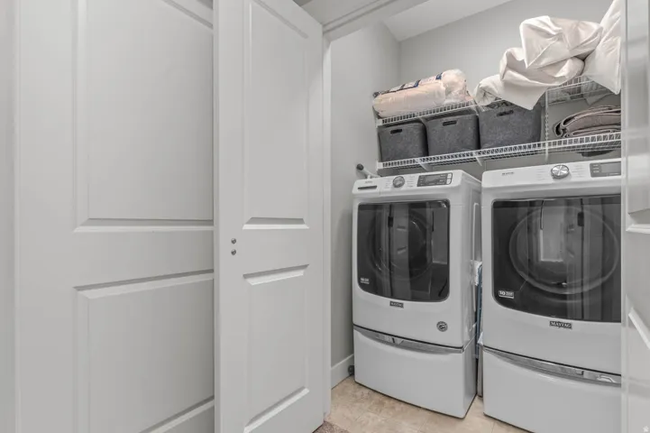 Dedicated laundry area featuring front-loading washer and dryer units