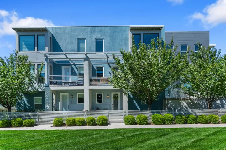 Contemporary multi-level townhome featuring a stucco and siding exterior