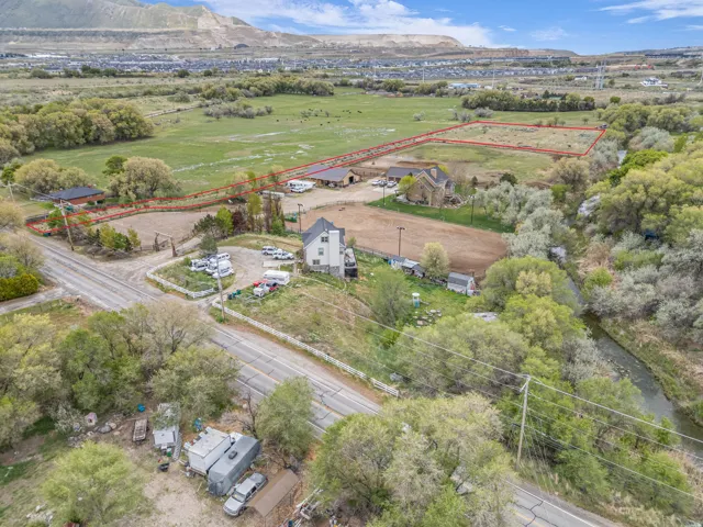 Expansive rural property featuring a large land parcel, established structures, and surrounding natural landscape