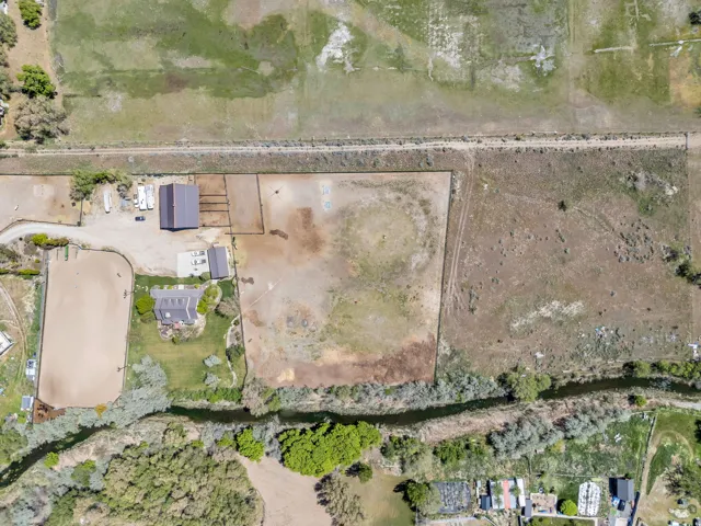 Extensive acreage featuring a main residence, a large barn, and a substantial riding arena