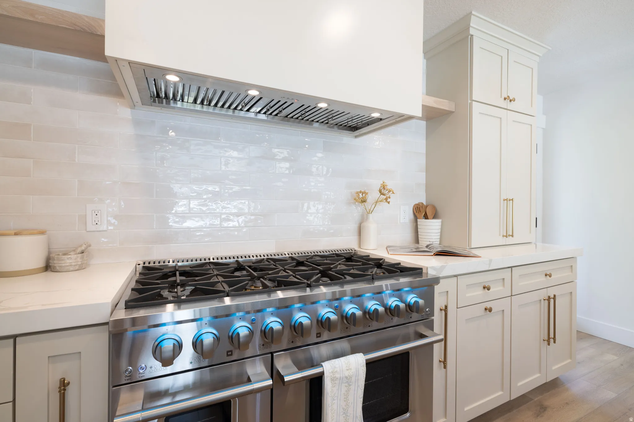 Stainless steel range with illuminated controls and a coordinating range hood
