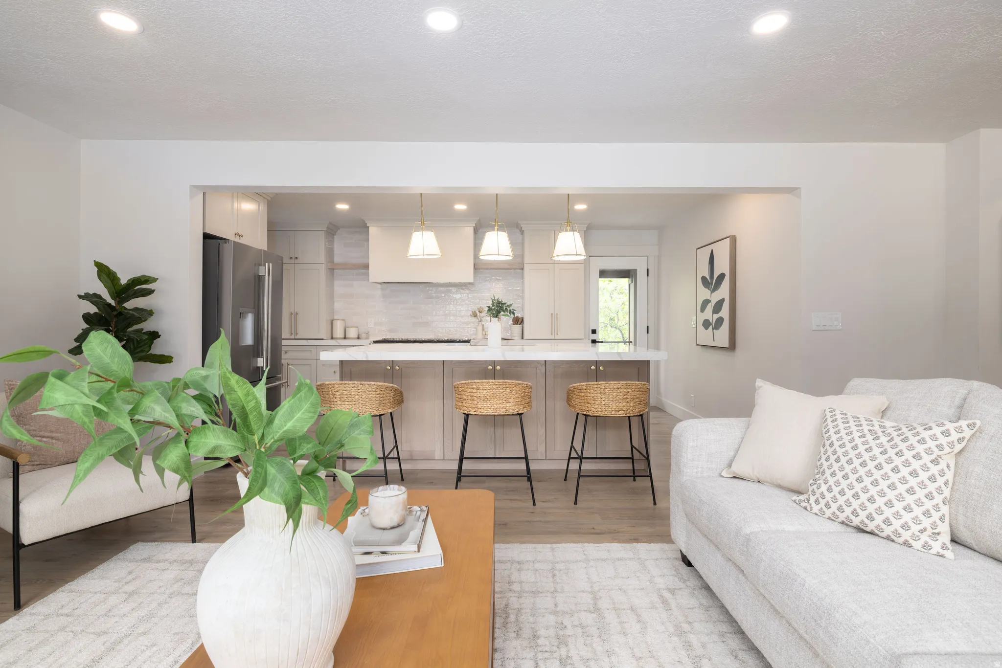 Open concept living space featuring recessed lighting, light wood-finish flooring, and a kitchen with stainless steel appliances