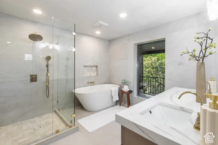 Walk-in shower with clear glass enclosure and rainfall showerhead