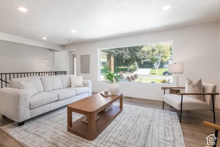 Recessed lighting, wood-finish flooring, and a large picture window